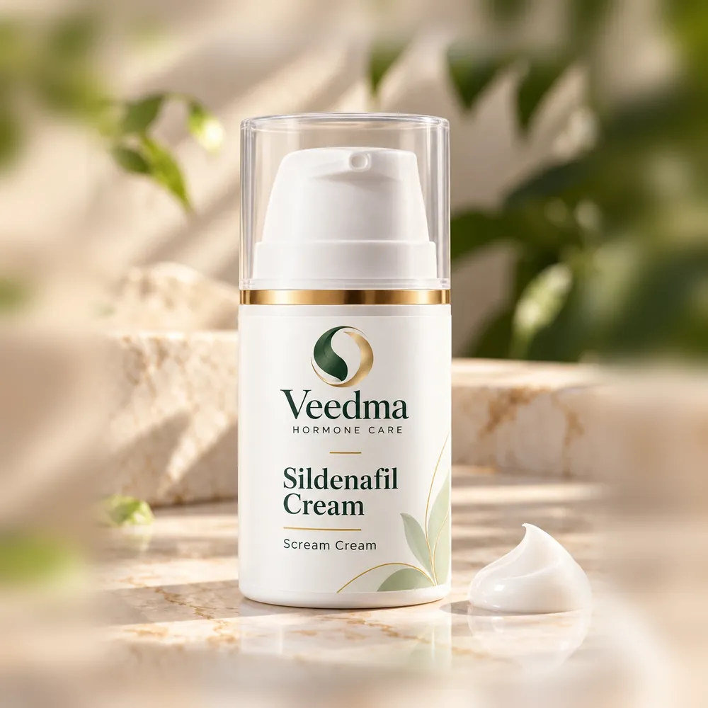 Veedma sildenafil cream in a white pump bottle with a clear cap, a dollop of cream beside it on a sunlit marble step